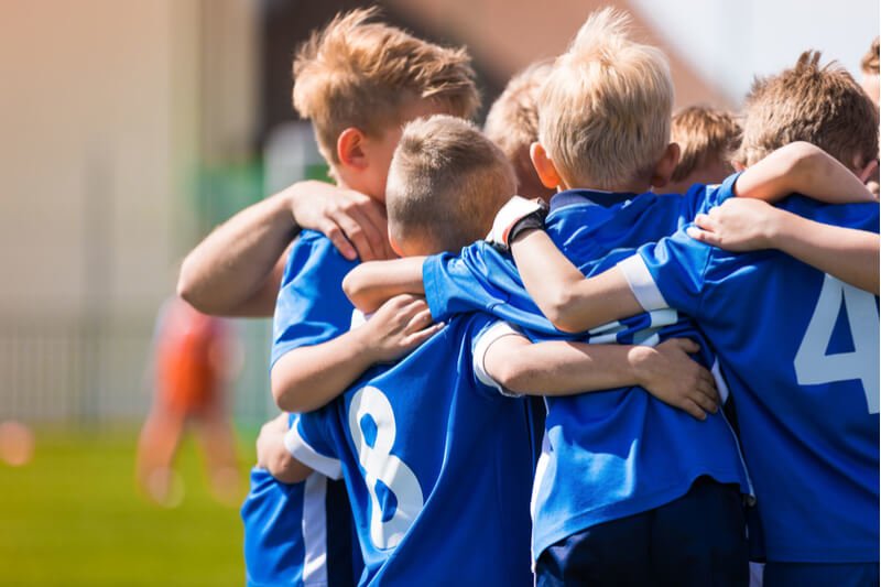 School children in rugby huddle